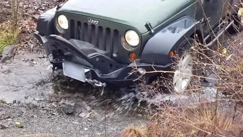 Jeep driving through small stream Stock Footage 172564863