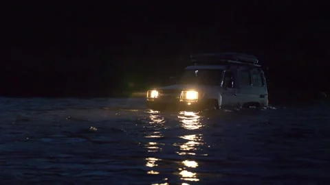 Jeep forcing a river at night2 Stock Footage 236144215