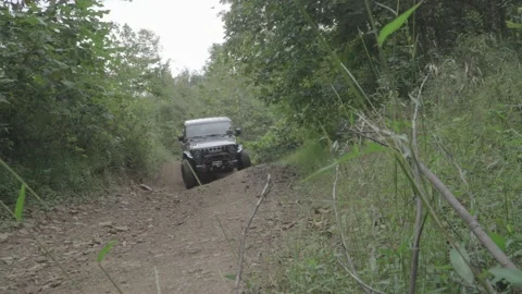 Jeep Gladiator driving over off road obstacle. Sony S-Log3.cine ProRes 4444 Stock Footage 236410231