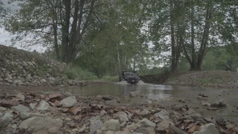 Jeep Gladiator driving off road through water crossing s-log3.cine prores 4444 Stock Footage 236409953