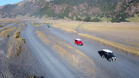 Jeep group touring to Mount Bromo by crossing the Mount Bromo desert Stock Footage 285835544