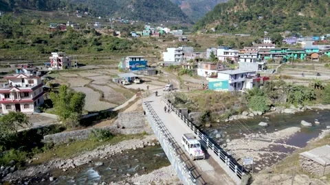 A jeep passing through bridge in the mountain city in Nepal Stock Footage 155368274