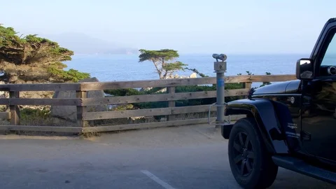 Jeep Pulls In at Lone Cypress in Pebble Beach Tracking Shot Stock Footage 80964710