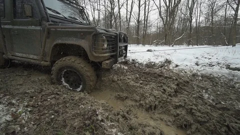 Jeep rides through the mud Stock Footage 84389546
