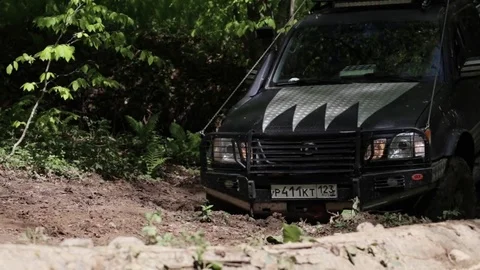 Jeep rides through the mud in the woods Stock Footage 75882867