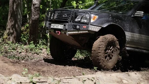 Jeep rides through the mud in the woods Stock Footage 75882948