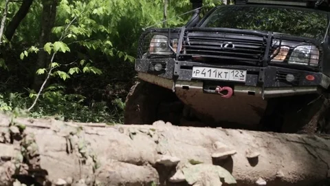 Jeep rides through the mud in the woods Stock Footage 75882982
