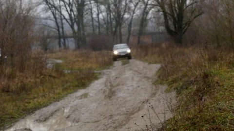 Jeep rides through the mud in the woods Stock Footage 83673828