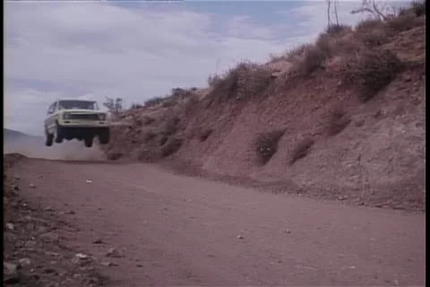 Jeep speeding down dirt road Stock Footage 11349900