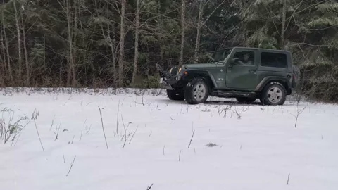 Jeep turning in snow Stock Footage 172564949
