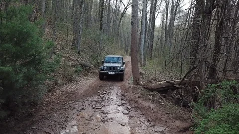 Jeep Wrangler Off-roading Through Mud Stock Footage 123981369
