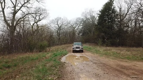 Jeep Wrangler Off-roading Through Mud Stock Footage 123981371