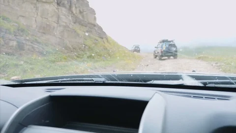 Jeeping in mountains, view from windshield of off-road car on jeeps and rocks. Stock Footage 114608904