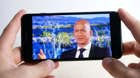 Jeff bezos interviewed and seen from the smartphone, Amazon Stock Footage 161635936