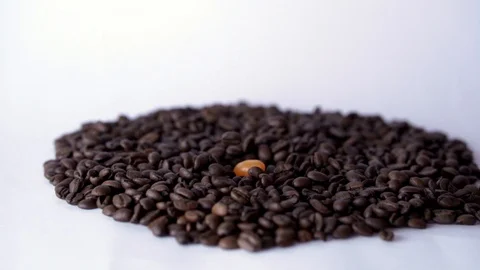 Jelly beans of different colors falling down on pile of roasted golden 스톡 동영상 129293232