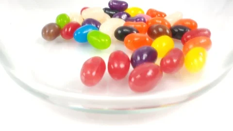 Jelly beans falling into container. Stock Footage 106721528