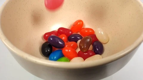 Jelly beans falling into container. Stock Footage 106721562