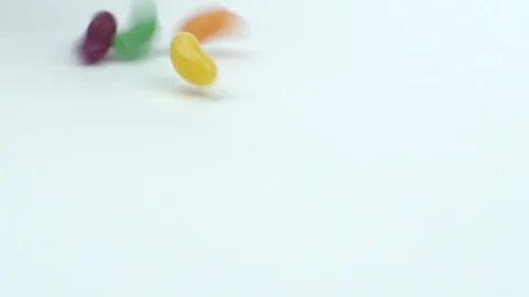 Jelly beans falling down on the table Stock Footage 87513031