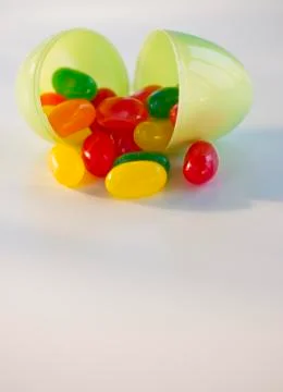 Jelly beans in a plastic Easter egg Stock Photos