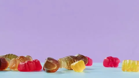 Jelly marmalade cola bottle bear falling down close up, Confiture Bean candy Stock Footage 261595876