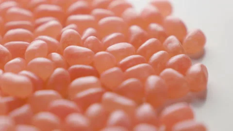 Jellybeans Rotating Loop peach apricot colour off centre Stock Footage 141095826