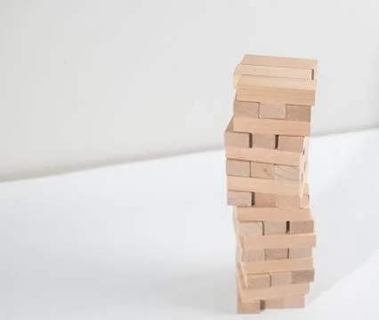 Jenga tower collapses on the white background Stock Photos
