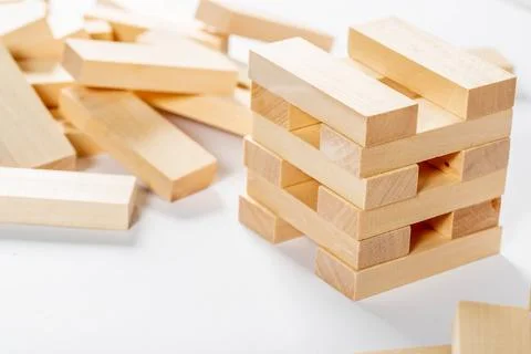 Jenga on white background, wooden rectangles for the game Stock Photos