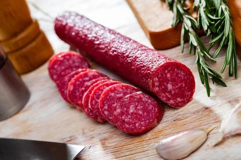 Jerked sausage of Fuet Nobleza with cut slices Stock Photos