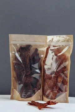 Jerky beef and spices on an old table in paper boxes Stock Photos