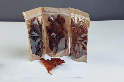 Jerky beef and spices on an old table in paper boxes Stock Photos