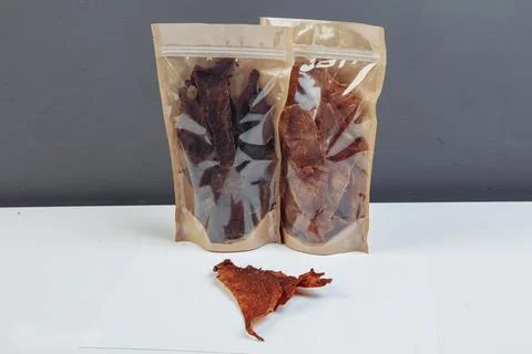 Jerky beef and spices on an old table in paper boxes Stock Photos