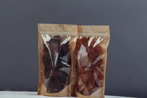 Jerky beef and spices on an old table in paper boxes Stock Photos
