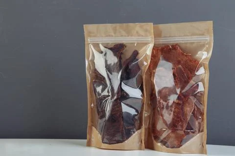 Jerky beef and spices on an old table in paper boxes Stock Photos