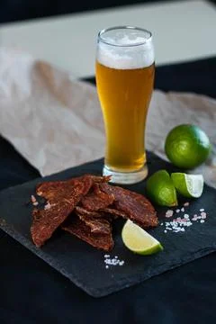 Jerky with beer laid out on the table Stock Photos