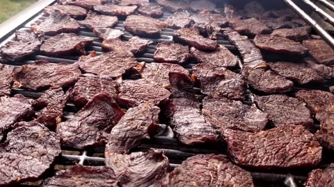 Jerky being made in custom modified gas grill for smoking and drying meats Video stock 163367987