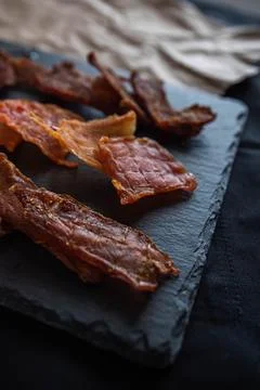 Jerky from different types of meat lie on a stone Stock Photos