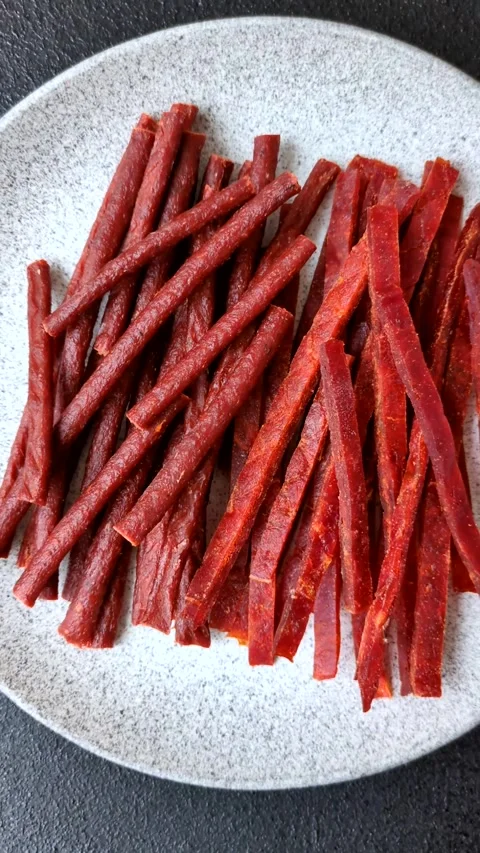 Jerky dried fish sticks with salt and spices Stock Footage 302116911