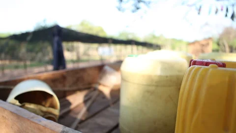 Jerry can filled with water being placed on back of truck Stock Footage 138147271