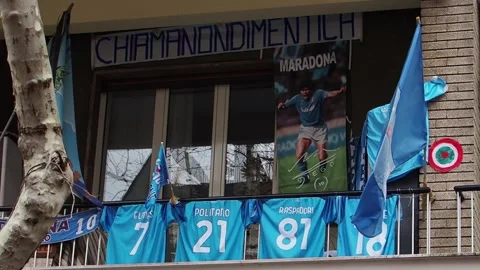 Jerseys of Napoli players with flags and banners, displayed on a balcony in t Stock Footage 240182146