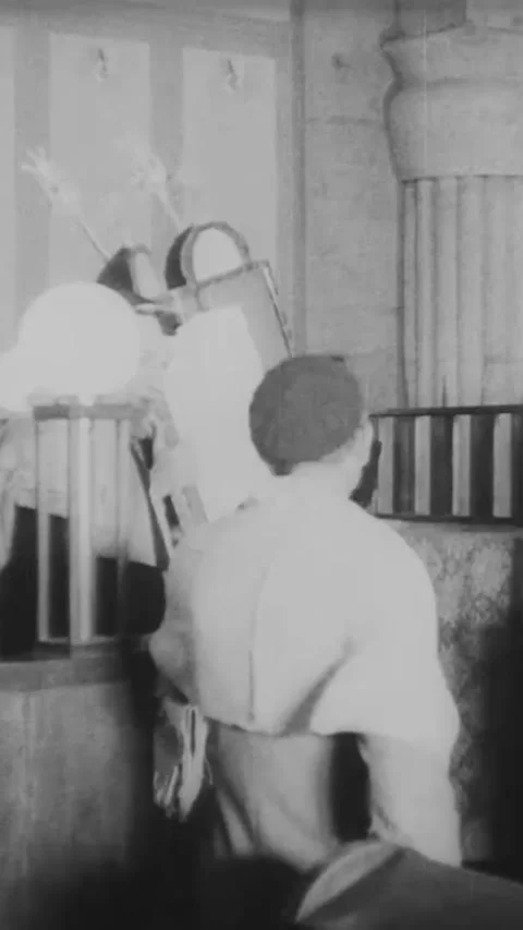 JERUSALEM - 1940s - The Torah is carried through a synagogue in Jerusalem. 動画素材 342923260