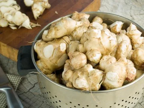 Jerusalem artichokes in a colander Stock Photos