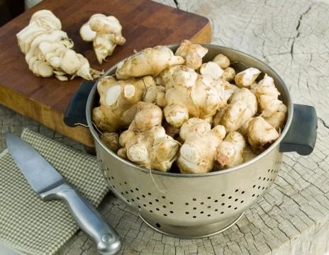 Jerusalem artichokes in a colander Stock Photos