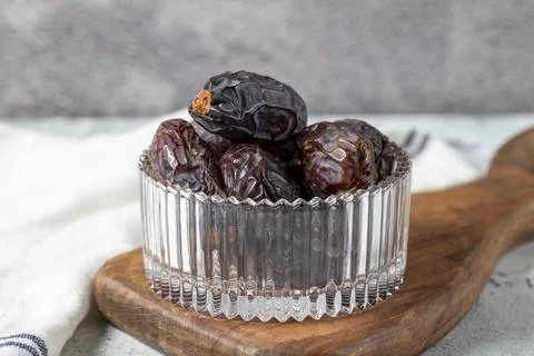 Jerusalem date fruit on stone background. Dried Big date fruit in a glass bow Stock Photos