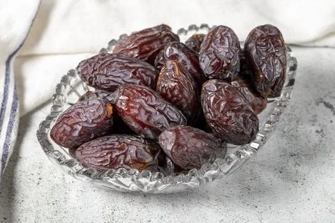 Jerusalem date fruit on stone background. Dried Big date fruit in a glass bow Stock Photos