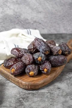 Jerusalem date fruit on stone background. Large date fruit on a wooden servin Stock Photos