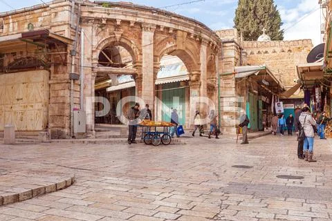 JERUSALEM, ISRAEL - FEBRUARY 17, 2013: Tourists buying souvenirs and bread o Stock Photos