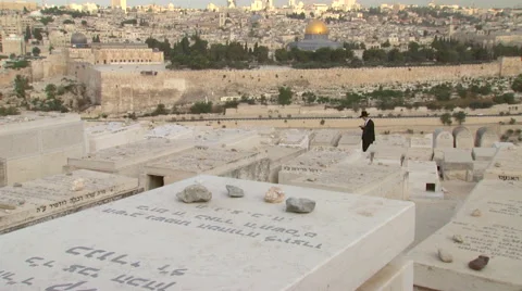 Jerusalem's Mount of Olives Graveyard, a praying Jew and the Dome of the Rock Stock Footage 65019772