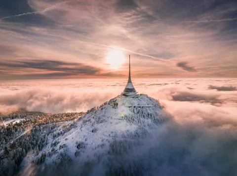 Jested tower mountain hill with snow mist and fog at golden hour Stock Photos