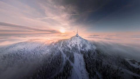 Jested tower mountain hill with snow mist and fog at golden hour Stock Photos