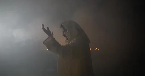 Jesus Christ in Ambient Light and Smoke Lifting Hands Praying, Worshipping Stock Footage 318430144